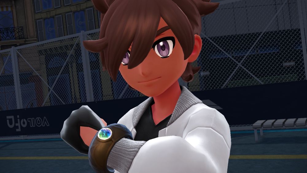 Screenshot from Pokémon Legends Z-A. Close up photo of Pokémon Trainer Zephyrus holding up his Mega Ring as he is about to Mega Evolve his Pokémon. 