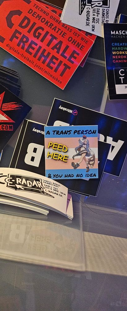 Funny sticker at 38C3, captioned "A trans person peed here & you had no idea"