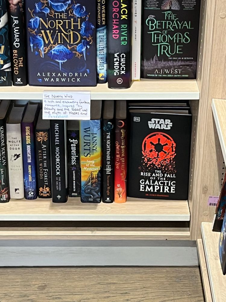 The book ‘The Rise and Fall of the Galactic Empire’ on a bookstore shelf with lots of other books