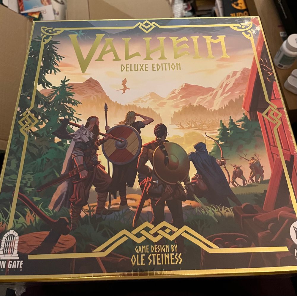 The front of the box for the Valheim board game. It has 4 Vikings looking out at a mystical world. 