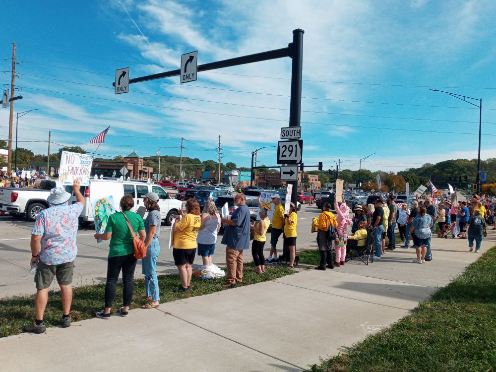 A crowd of protestors at a busy corner
