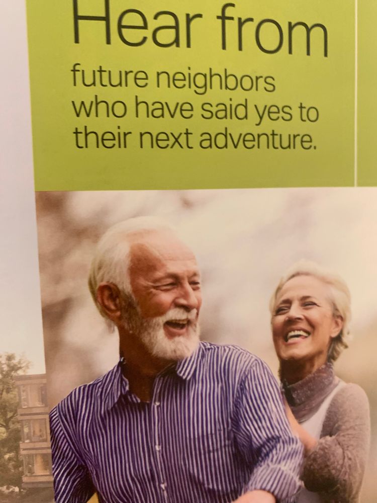 Two people laugh while considering senior living. 