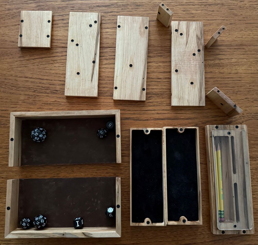 Wooden transformable dice tower disassembled on a table showing off all the pieces and magnetic connection points. 
