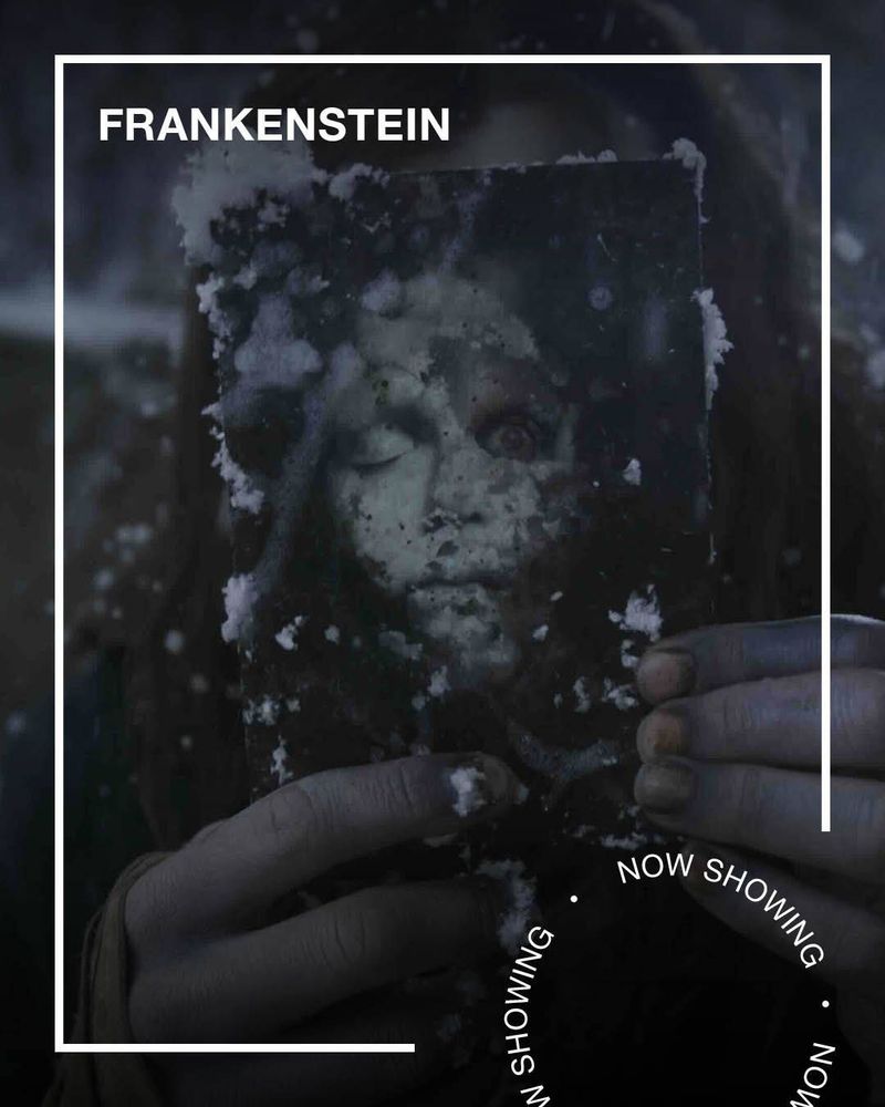 Dead fingers hold a photograph of a terrifying doll, covered in snow. Text - Frankenstein, Now Showing.
