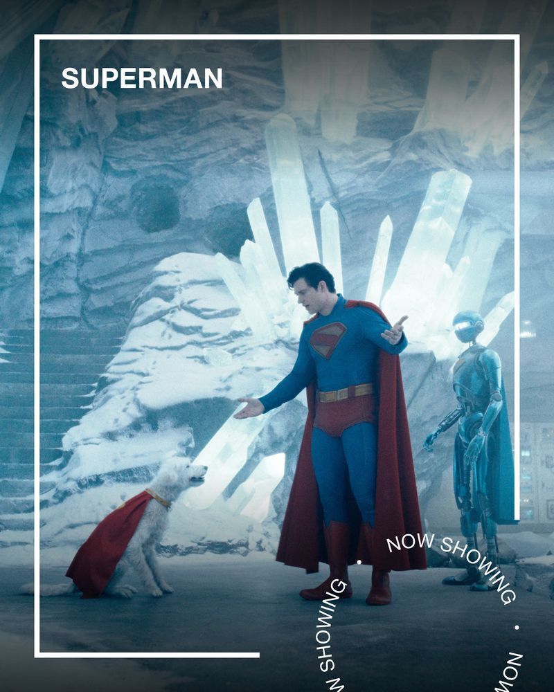 Superman talks to a dog wearing a cape and a robot in an ice cave. Text - Superman, Now Showing.