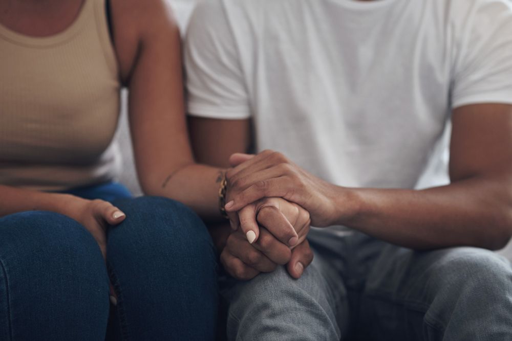 Two individuals holding hands.