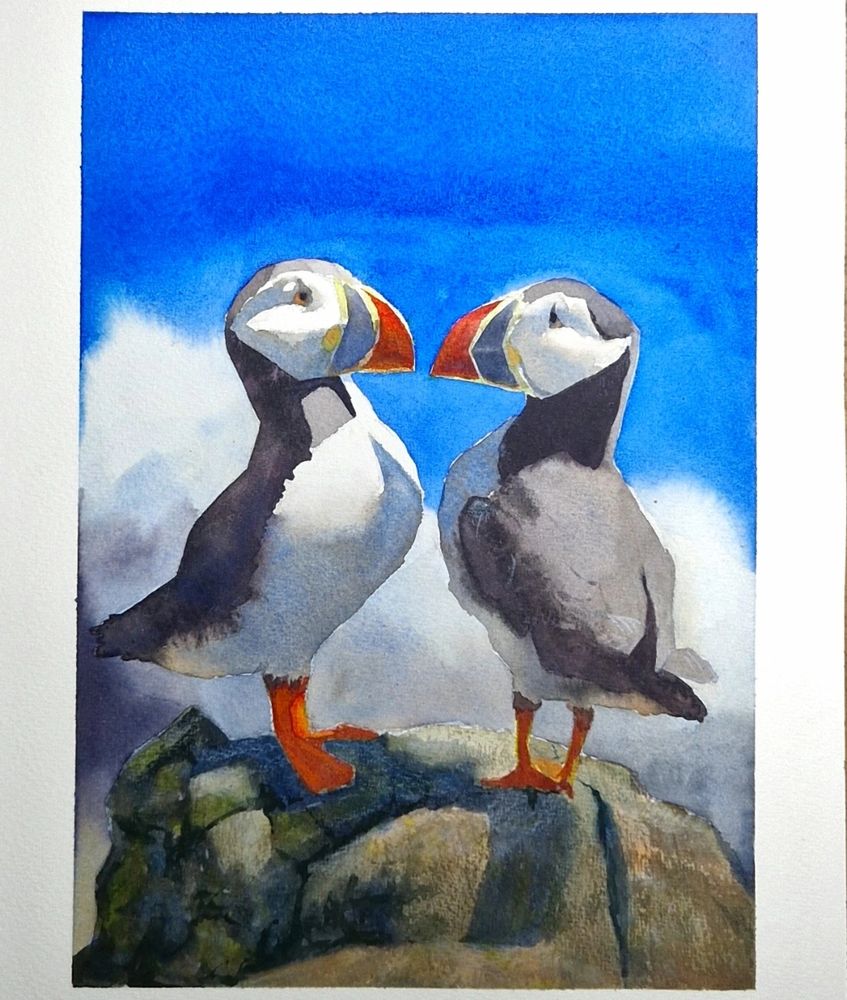 A watercolour painting of two puffins looking at eachother on a rock. There is an out of focus wave crashing in the background. The sun is casting shadows to the left side in the painting. 