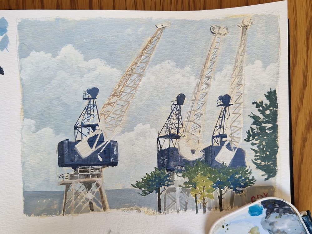 Gouache painting of three blue and white rusted cranes against a pale blue sky with some large fluffy clouds. The foreground shows several small green trees
