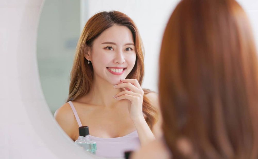 women-cheking-teeth-for-oral-care-pink-white.jpg