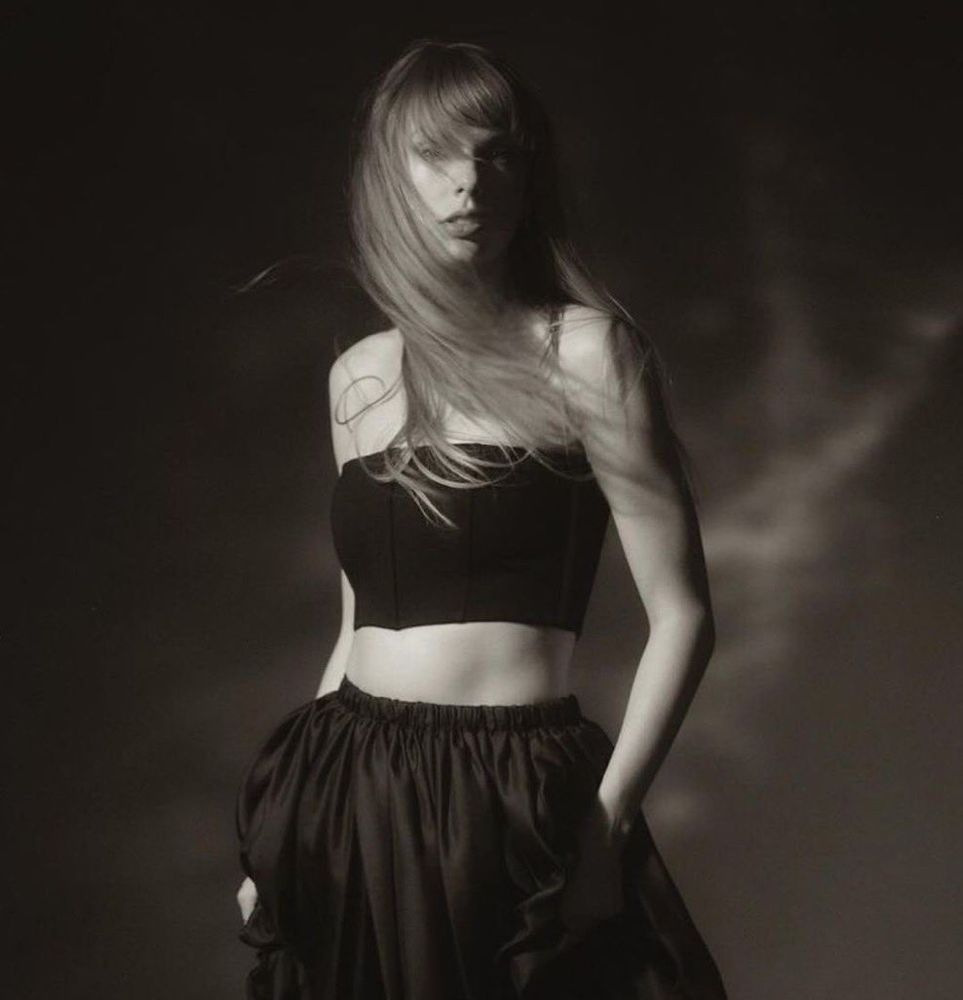 Taylor Swift for the TTPD photoshoot, in black and white, wearing a long skirt and crop top with no sleeves 