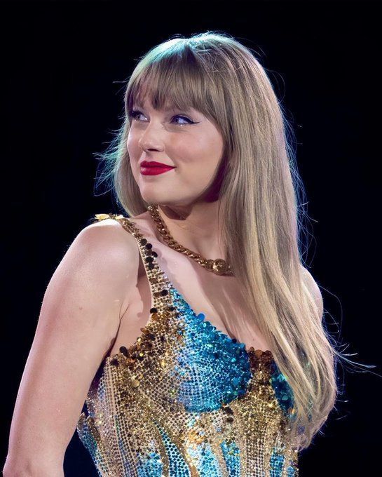 Taylor Swift at The Eras Tour with the blue and gold “Lover” bodysuit