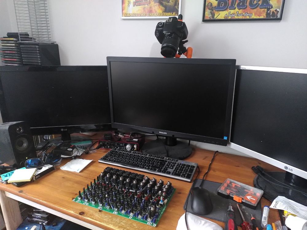 a wide shot showing the camera pointing at the desk from behind the monitor