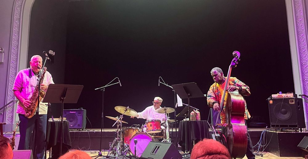 Marty Ehrlich on saxphone, Pheeroan akLaff on drums, and Hilliard Greene on bass.