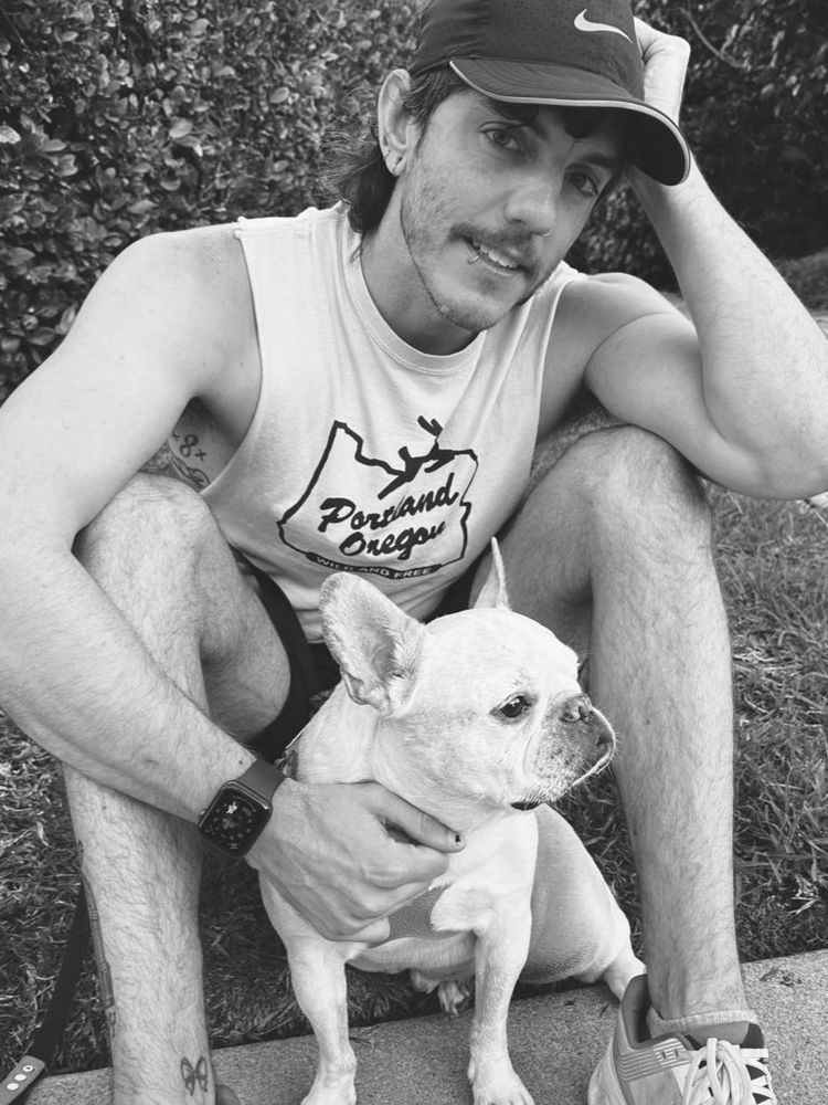 Black + white photo of Kasey + Von happily sitting in the grass