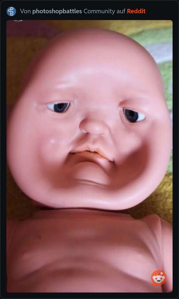 Rubber babydoll head whose face has been pressed into a concave position.