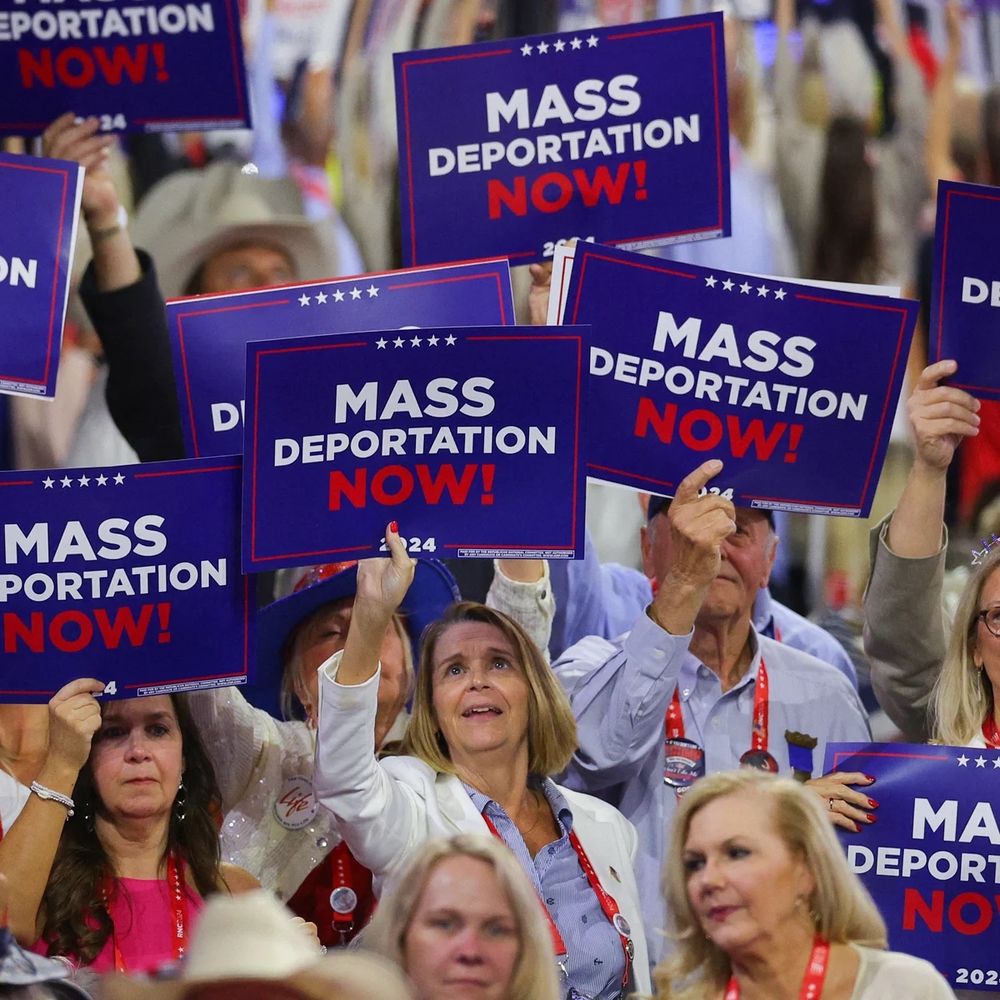 RNC attendees waving “Mass Deportation Now!” signs