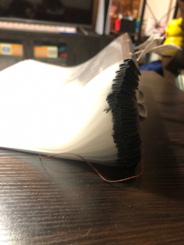 Side profile of a text block, the spine is much much thicker than the sheet protectors signatures. Kinda feel like I fucked up ngl