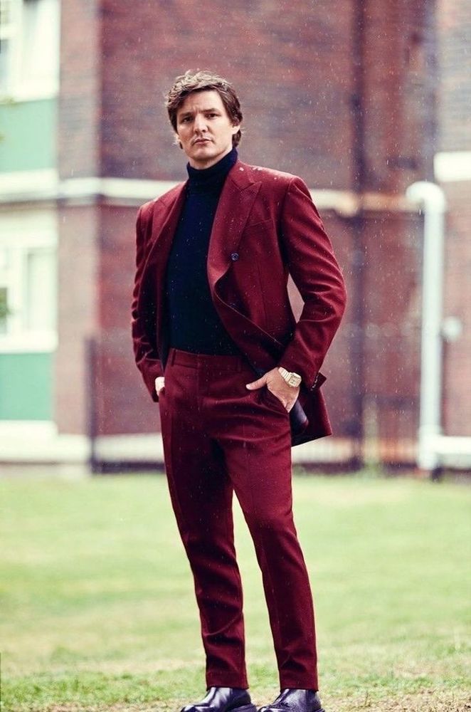 Pedro Pascal in a dark red suit and black turtleneck