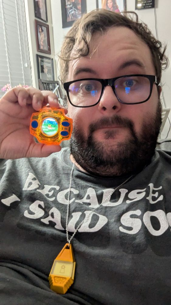 Guy holding an orange digivice and wearing the crest of hope