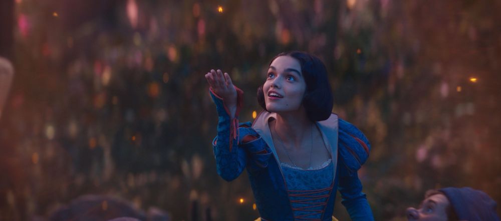 Still from the live action Snow White with Snow White holding her hand up, but no animals anywhere in sight 