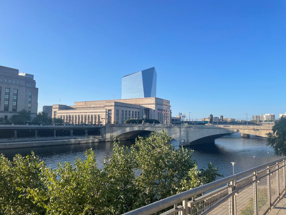 30th st station viewed in the late afternoon from south and across the schuykill river against a blue sky