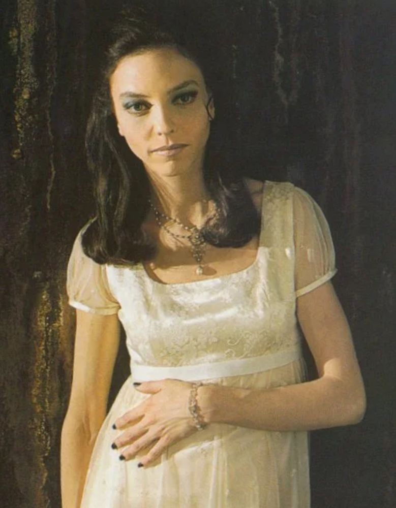 Juliet Landau as Drusilla from Buffy in a white chemise leaning against maybe a tree?