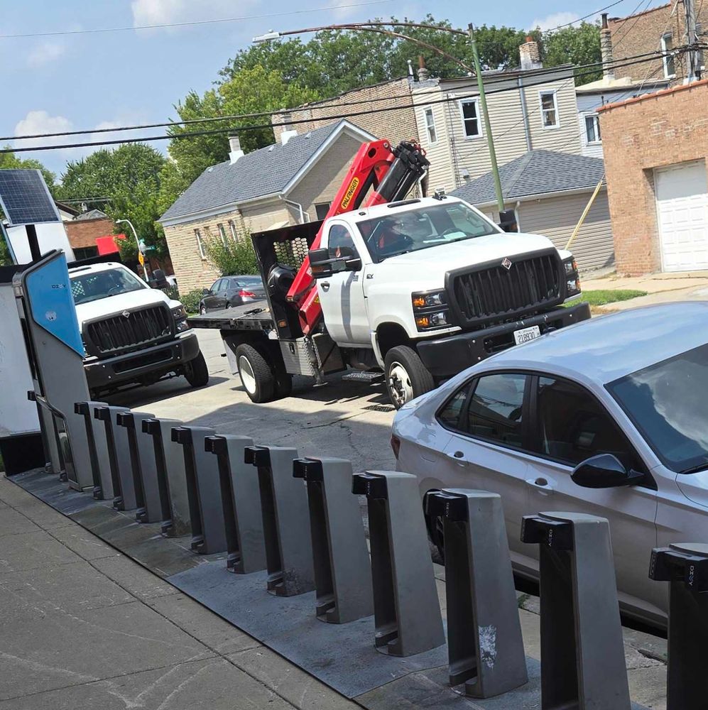 New DIvvy station on sidewalk with crane truck behind it