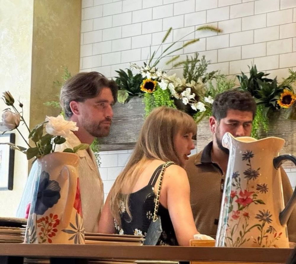 Travis Kelce and Taylor Swift in a store/cafe, location unknown.