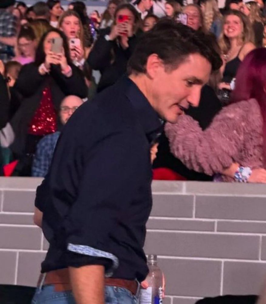 Photo of Justin Trudeau turned to the side at Taylor Swift’s Eras Tour in Toronto while holding bottle of water. 