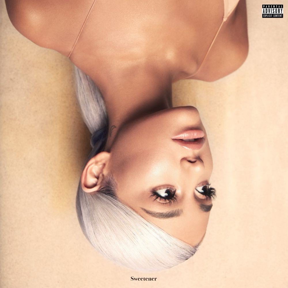 Ariana Grande with grey ponytail, upside looking to the side. 