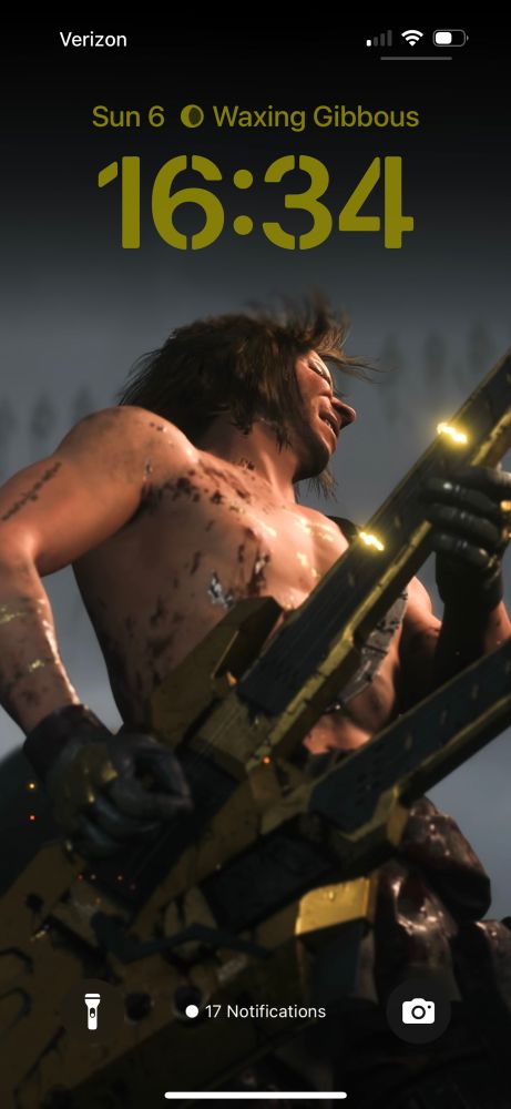 screenshot of Higgs from Death Stranding 2 playing a double-neck guitar, set as iphone lock screen