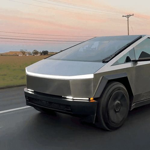 a futuristic car is driving down a road