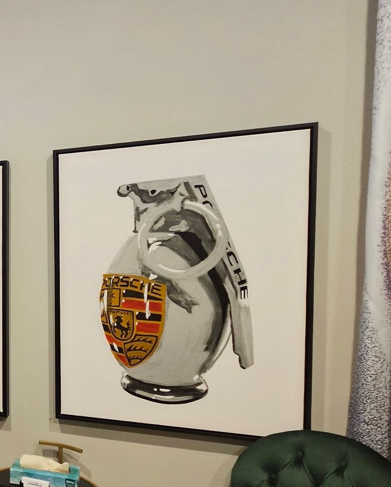A photo of a grenade that has the Porsche symbol painted on it