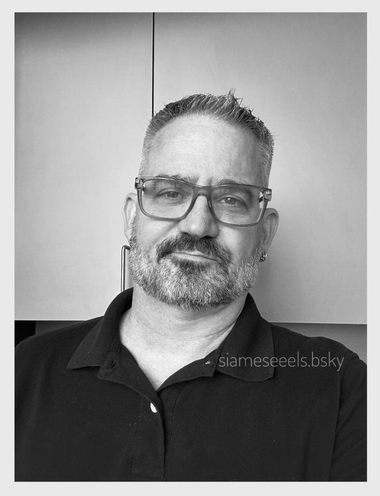 A selfie in black and white. I’m standing in the kitchenette at work. 