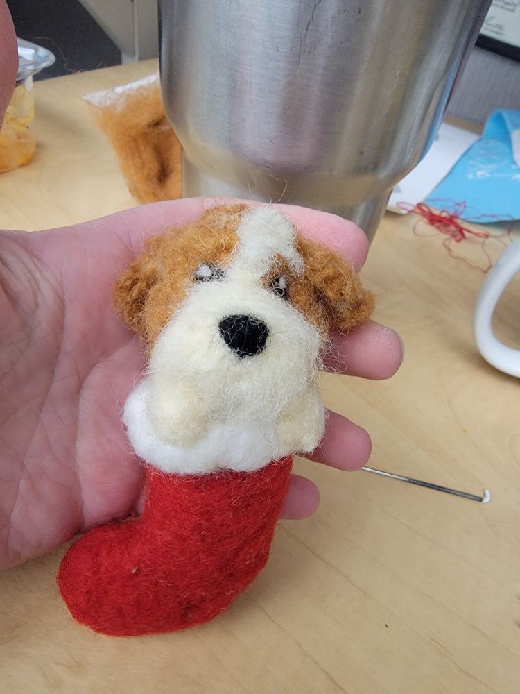 Needle felted dog in stocking.