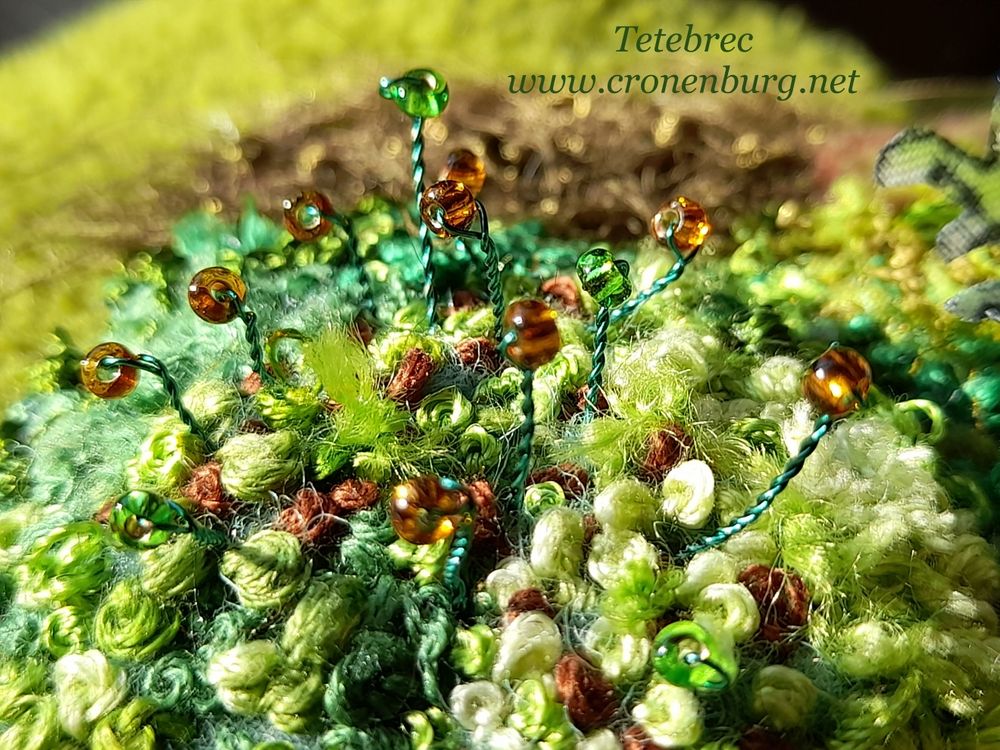 Finished moss in different green shades with some sporophytes. They are made with green and brown glass beads on extremely thin green wire.