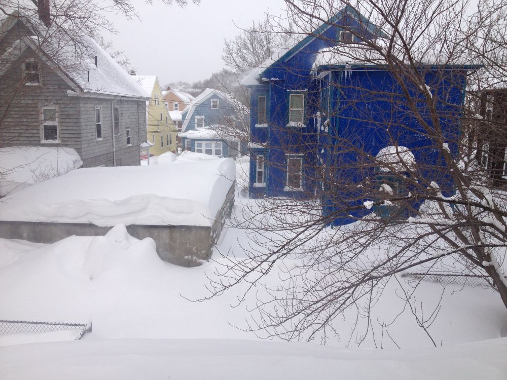 A photo of garage with snow almost to the top of it.