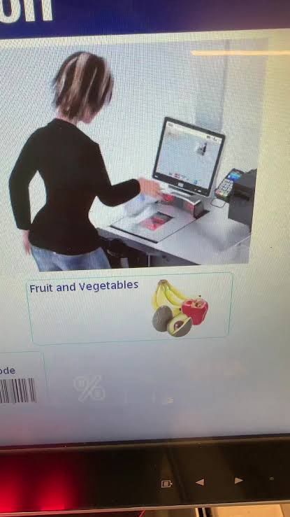 A screenshot from the ALDI self-checkout machine. It depicts a 3d animation of a woman with Hartman hips and VERY chunky blonde highlights using a self-checkout machine.