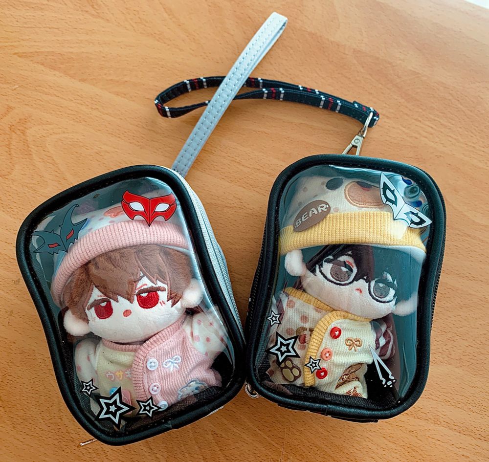 Pictured: Two small ita-bag inspired pouches based on the Persona 5 series. One is based off Goro Akechi and the other is based off the P5 protagonist. Svn has immediately trapped her nuis in there LOL