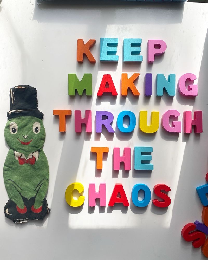 The words keep making through the chaos have been spelled out in wooden block letters. A small vintage cut-and-sew frog is to the left 