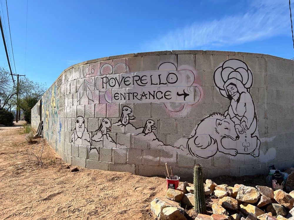 A mural underway at Tucson Poverello House featuring cheeky ground squirrels and St 
Francis with the wolf

painted by Molly Kiely