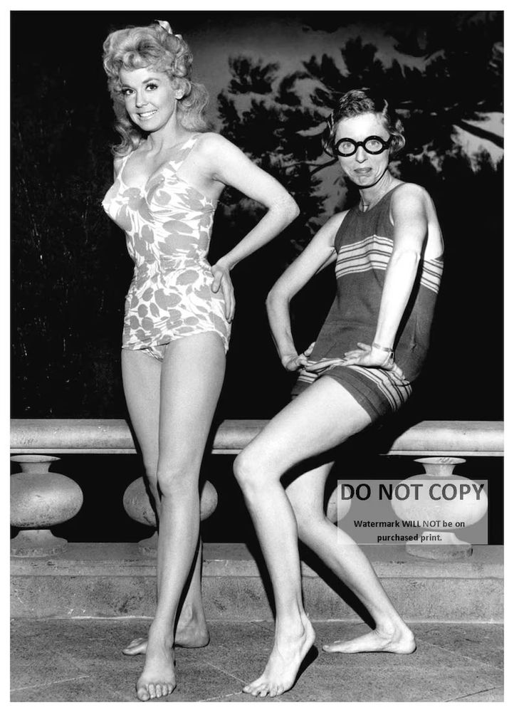 Donna Douglas strikes the typical bathing beauty pose -- poised, aware of her best angles, wearing a fashionable swimsuit -- while Nancy Kulp on the right is fully self actualized, free, and goofy in a comfy swimming outfit and oversize glasses

(she may want to remove those prior to swimming)

posted on the photo is a watermark that says: do not copy watermark will not be on purchased print

i did not copy this photo; no, i stoled it offa ebay