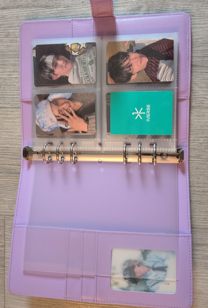 A lilac faux leather binder to hold photo cards. The first page is filled with 1Verse photo cards and the side bar has a 3D Baekhyun photo card in it.