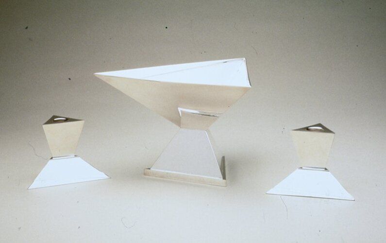 Triangular shaped bowl on pedestal
Many of America's strongest proponents of avant-garde design in the early twentieth century were European-born immigrants, including Elsa Tennhardt. Her severe geometric forms, like this centerpiece bowl and candlesticks, echo tenets of Cubism and Russian Constructivism - perhaps an influence of her early training as a painter in Germany. Although recognized today as a visionary, Tennhardt's name was virtually unknown at the time. Silver design in America was less receptive than other areas of the decorative arts to European modernist influences. To many, silver was still something passed down from one generation to the next. Consequently, few American silversmiths accepted the challenge of European avant-garde design, and even fewer created works more audacious than Tennhardt's centerpiece bowl and candlesticks.