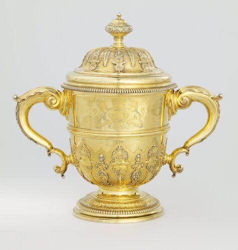The royal arms of Queen Anne adorn this cup, along with the crest of John Smith, who served as her Speaker of the House from 1705 to 1708. The nearly 100 ounces of silver used to make this piece are believed to have been awarded to Smith for fulfilling his governmental duties. After his death in 1723, Smith's heir had the silver remade into the latest style, but with earlier emblems of Smith and Queen Anne, a tradition of honoring one's ancestry that continued into the 19th century.