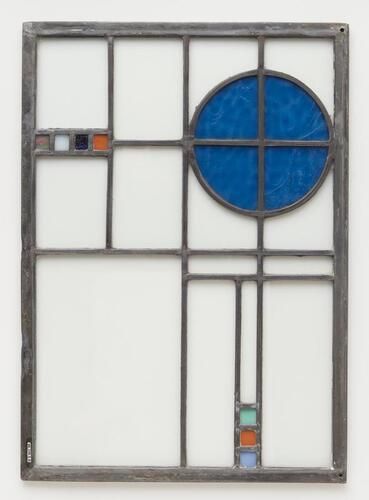 clear glass panels with blue circle on one side; 4 small squares opposite (green and pink swirled, white, dark blue and orange) and 3 squares at one short side (blue, orange, green)