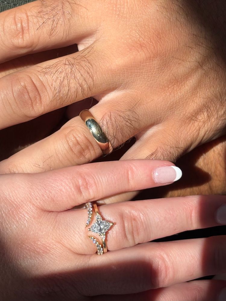 Cat and her husband showing off their rings 🥲