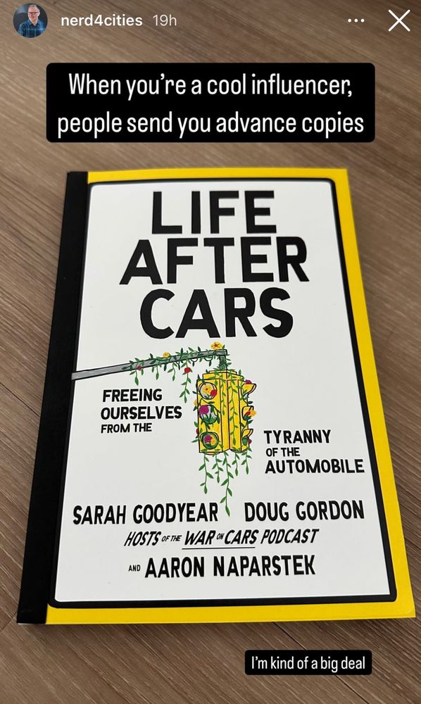 Screenshot of Instagram story from nerd4cities that says "When you're a cool influencer, people send you advance copies. Picture is a book cover for "Life After Cars," with a yellow border and white background with black lettering with an illustration of a traffic light with vines on it. 