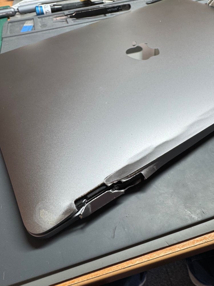 Badly damaged MacBook display, hinges mangled