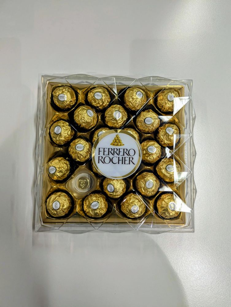 A tray of Ferrero Rocher chocolates with one missing 